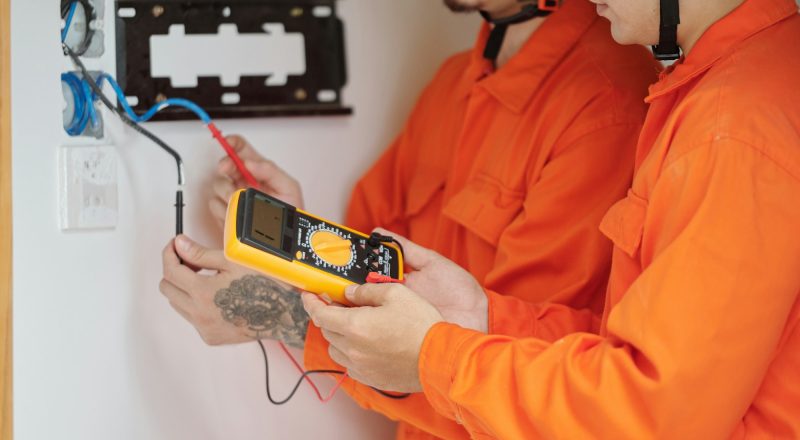 Electricians Fixing Wiring in House